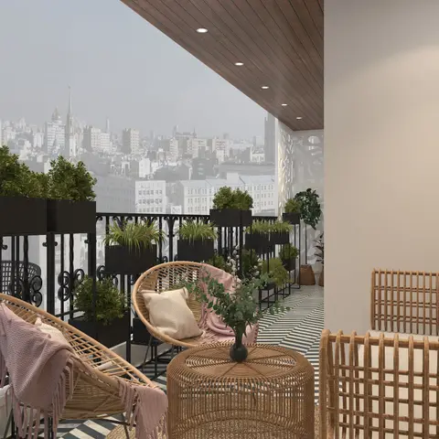 Boho-styled balcony with round rattan chairs, a woven rattan drum table, a row of black planters along the railing