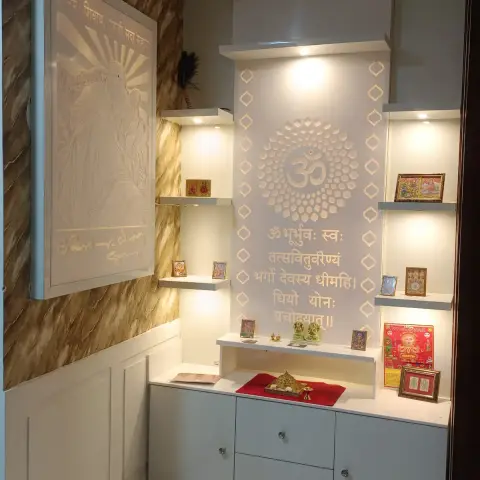 Built-in pooja unit with a backlit CNC-cut om medallion and Gayatri mantra inscribed above the deity shelf, flanked by lit display niches