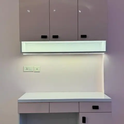 Built-in study desk with a lilac gloss overhead cabinet featuring integrated under-cabinet strip lighting