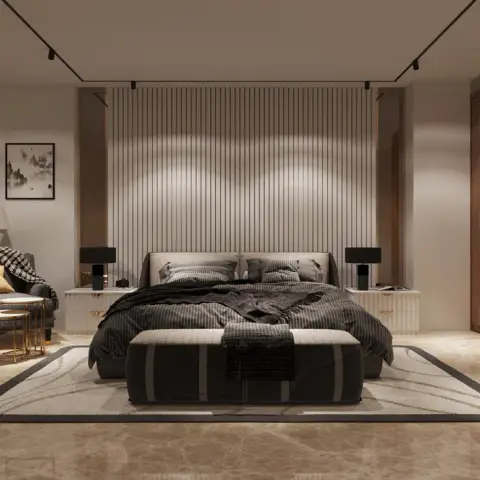 Charcoal-dressed bed on a beige marble floor, with a floor-to-ceiling fluted panel behind the headboard