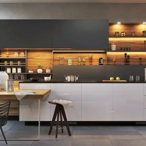 Charcoal handleless kitchen with warm wood-backed open shelving and integrated lighting, wooden island-height dining table with wire-frame chairs