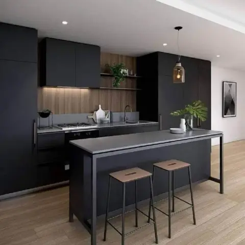 Charcoal matte handleless kitchen against a vertical wood-slat backsplash with two floating shelves of greenery