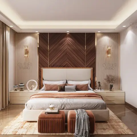 Chevron-laid walnut headboard panel flanked by beige fluted slats and gold sconces, with two rust velvet ottomans at the foot of the bed.