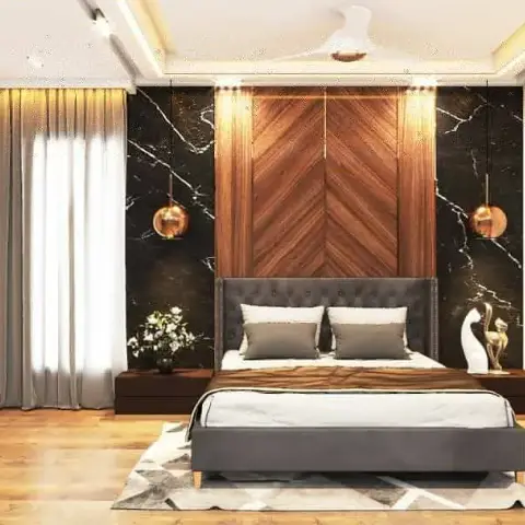 Chevron walnut headboard panel framed by black-marble flanks and copper globe pendants, a tufted grey bed on a hide-pattern rug