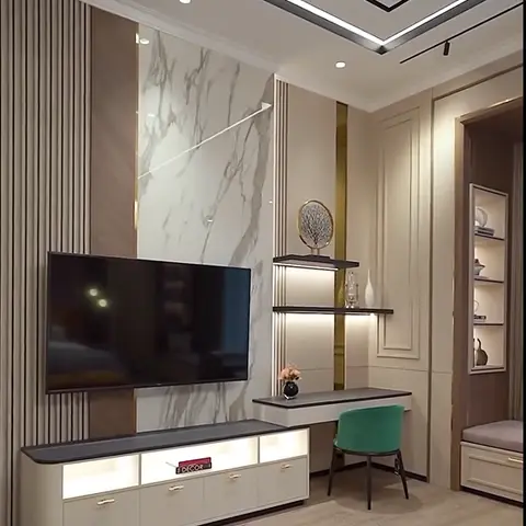 Combined TV and study unit with a marble accent panel, fluted wood panelling and a built-in desk with a green velvet chair.