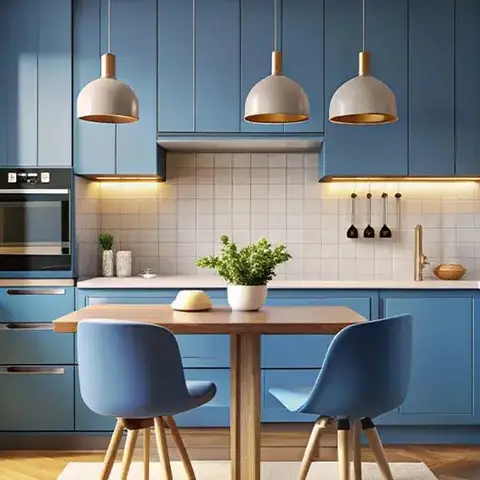 Compact blue shaker-style kitchen with a white square-tile backsplash, three dome pendant lights over a small wood dining table with matching blue chairs