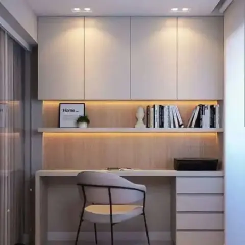 Compact home-work nook with cream handleless overhead cabinets, a floating white shelf and desk top backed by an oak veneer panel