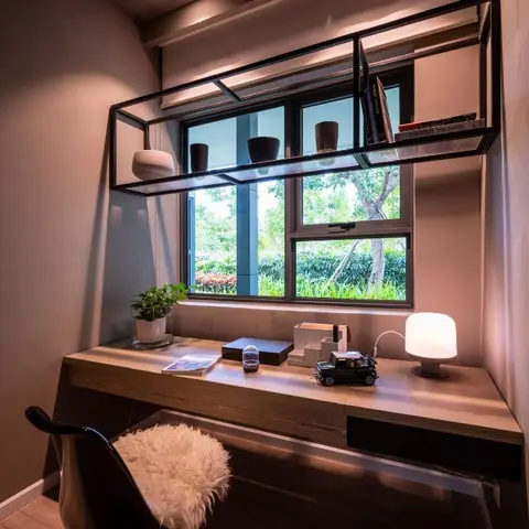 Compact study nook with a floating wood desk under a window, a black metal box-shelf above holding books and decor