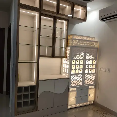 Corner mandir with backlit jaali shutters and the Gayatri mantra cut into its cornice