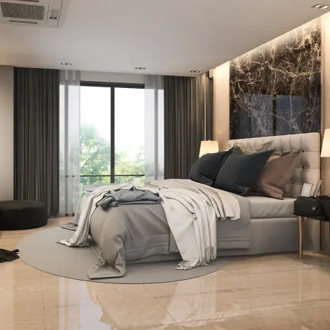 Corner master bedroom where a book-matched dark marble slab panel rises behind a buttoned pale headboard