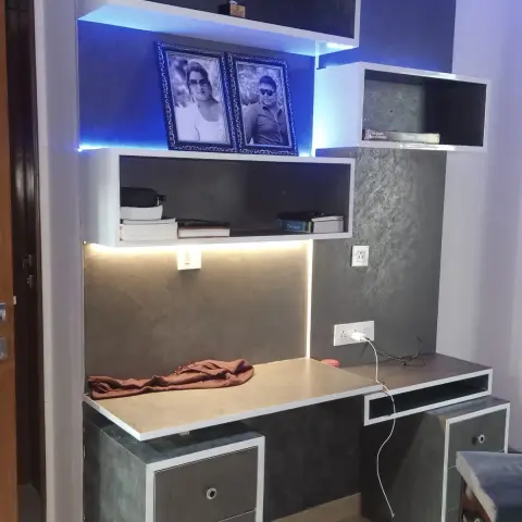 Corner study table in grey concrete-finish laminate with white edge banding, two drawer pedestals with ring pulls