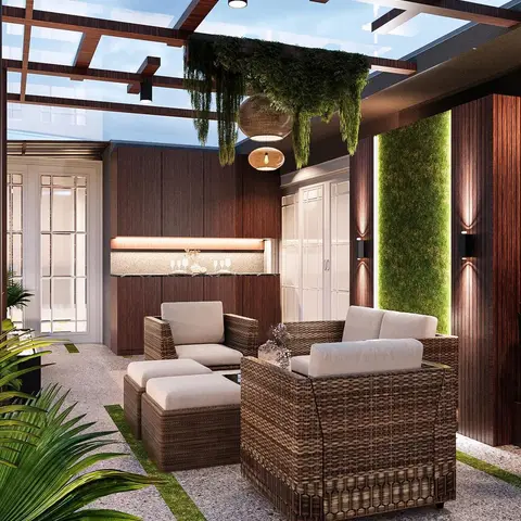 Covered balcony lounge with woven rattan sofas under a wood pergola hung with trailing greenery, beside a live moss feature wall.