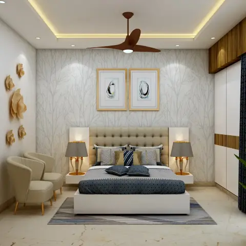 Cream button-tufted headboard flanked by floating nightstands and gold candlestick lamps against silver branch-print wallpaper