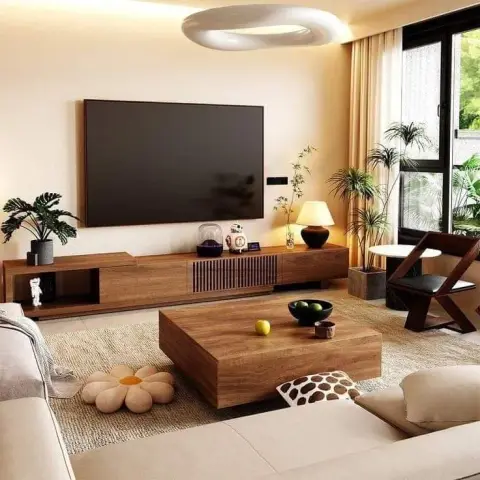 Cream living room with a long low walnut media unit under a wall-hung TV, a solid-wood block coffee table on a jute rug