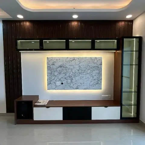 Dark fluted wood TV wall with a backlit marble-look centre panel, a row of four glass-front lofts