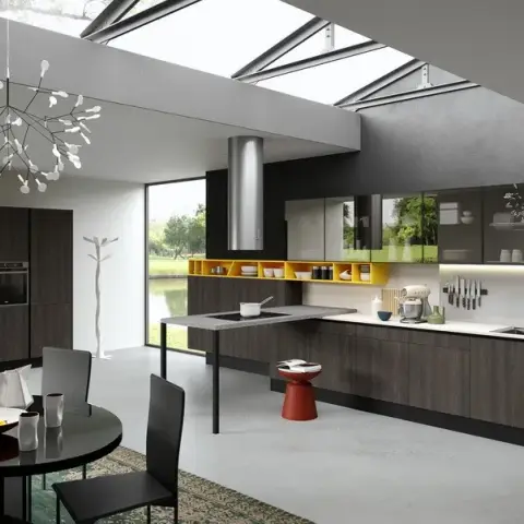 Dark oak handleless kitchen run under a long roof skylight, with mustard-lined open niches breaking the wall units