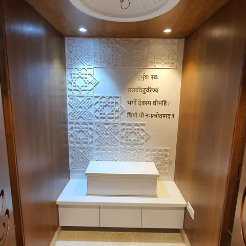 Dedicated pooja room with wood-panelled walls, a white carved jaali backwall inscribed with the Gayatri mantra