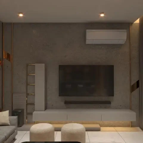 Dim TV wall in mottled grey concrete-finish plaster with a wall-hung light-grey console floating over a lit plinth, a slim brass ladder shelf to one side