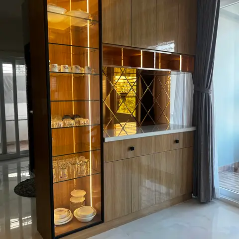 Dining-area crockery and bar unit with a backlit glass display cabinet, a diamond-mirror splashback, and glossy wood-veneer cabinetry topped with white marble.