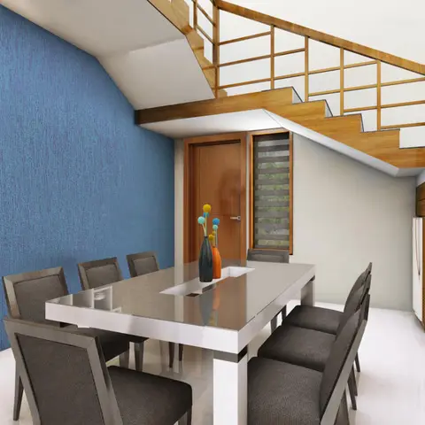 Dining area tucked beneath a wood-railed staircase, with a blue textured accent wall and a glossy white dining table seating eight.