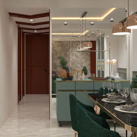 Dining area with a black glass gold-trimmed table, emerald velvet chairs and gold pendant lights beside a mint-green bar console