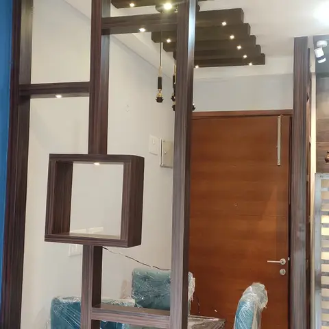 Dining area with a fretwork wood room divider featuring lit display cubes, a stepped wood-slat ceiling with pendant lights
