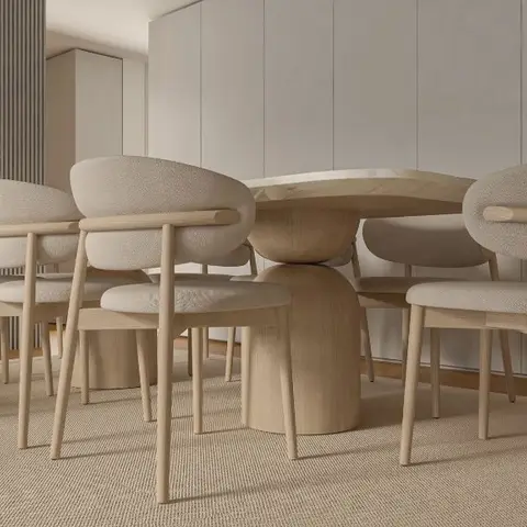 Dining area with a round marble-top pedestal table and upholstered curved-back chairs in front of a fluted wood-panel wall and floor-to-ceiling wardrobe.