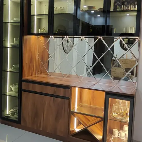 Dining feature wall with a wood-and-black crockery unit, a diamond-cut mirror backsplash, and a built-in wine rack with glass shelving.