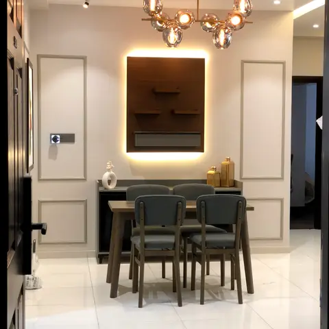 Dining nook with a backlit walnut display panel, a brass multi-globe pendant chandelier over a four-seater wood table