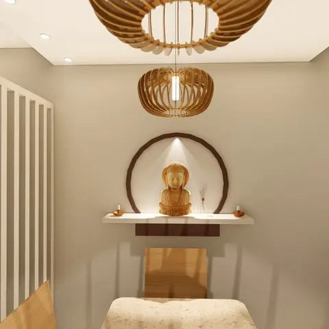 Dining nook with a circular wall niche holding a wooden Buddha bust, flanked by twin rattan drum pendant lights and a vertical wood-slat partition.
