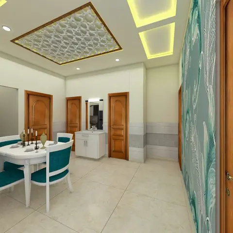 Dining nook with a round white table and teal upholstered chairs beneath a decorative jaali-pattern false ceiling