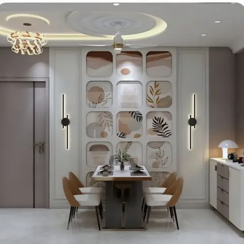 Dining nook with a spiral POP false ceiling, a grid of framed abstract wall art panels, and a marble-top table with tan bucket chairs.