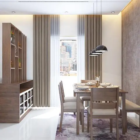 Dining nook with a wood table, cushioned bench and chairs beneath a cluster of dome pendant lights, a wood display console dividing it from the living area