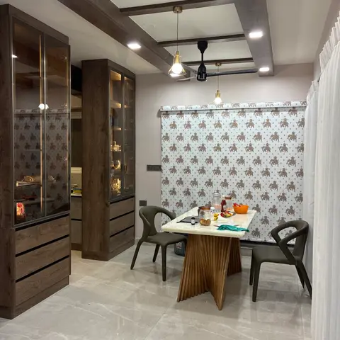Dining nook with elephant-motif wallpaper backdrop, a sculptural pleated-wood-base marble dining table, olive bucket chairs