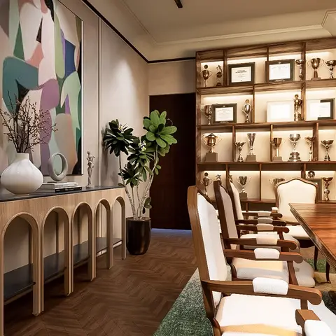 Dining room with a backlit open shelving unit displaying trophies and framed certificates, a wood dining table with upholstered wingback chairs