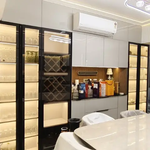 Dining room with a black-framed glass crockery-and-bar display unit featuring a diamond wine rack and internal shelf lighting.