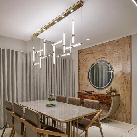 Dining room with a marble-top table for six beneath a sculptural tube-and-orb chandelier