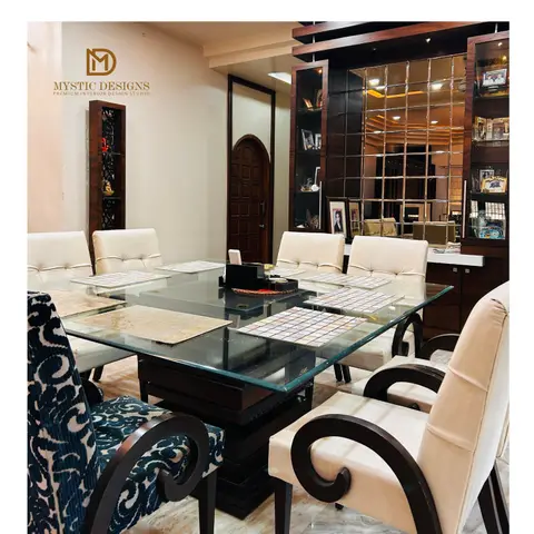 Dining room with a square glass-top table, ornate scroll-arm chairs in cream and teal-patterned upholstery