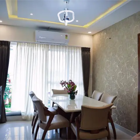 Dining room with a textured branch-pattern wallpaper, a geometric pendant over a marble-top table, and a dark textured stone accent wall by the console.