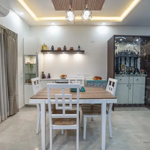 Dining room with a white-and-wood four-seater under two geometric cage pendants, a wood-slat ceiling raft with cove light