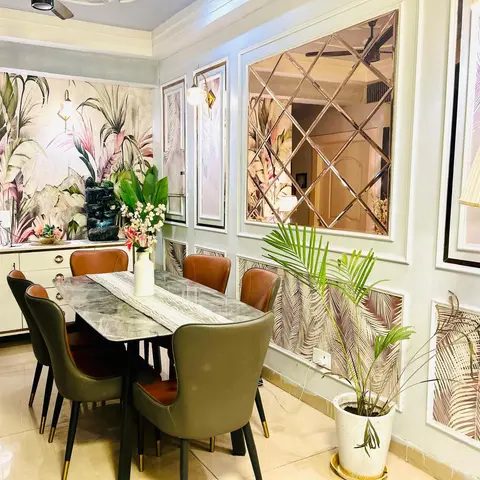 Dining room with botanical-print wallpaper, wall panelling framing a diamond-pattern mirror mosaic