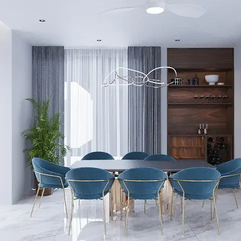 Dining room with teal velvet gold-frame chairs around a dark table, facing a walnut open-shelf bar unit with wine storage