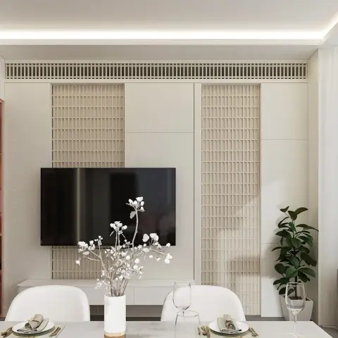 Dining table set for a meal in front of a fluted wood-lattice TV feature wall with cove ceiling lighting