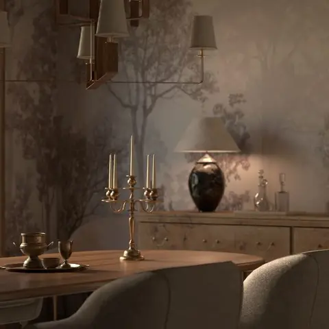 Dining table with brass candelabras in front of a moody grey forest-mural wallpaper wall and a carved wood sideboard.