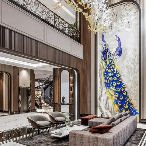 Double-height living lobby with a channel-tufted sofa, wrought-iron mezzanine railing, a spiral staircase, and a large peacock mural on the feature wall
