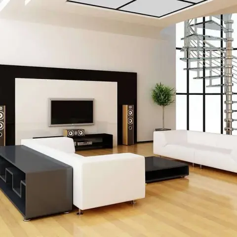 Double-height living room render with two white leather sofas facing a TV set into a black-framed white panel