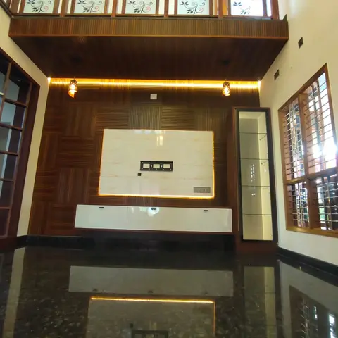 Double-height living room TV wall with geometric wood panelling, a marble-look TV backboard, a white gloss floating console, a lit glass display niche