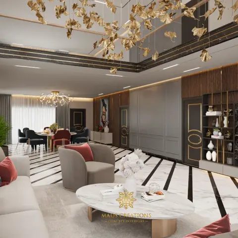 Double-height living room under a suspended installation of gilded ginkgo leaves, with a cream sofa and dusty-rose cushions