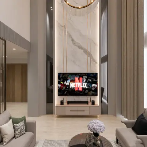 Double-height living room where a white-veined marble slab runs the full wall behind the TV, strung with slim brass rods and back-lit at the edges