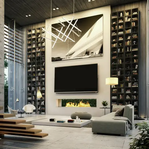 Double-height living room with a floating timber staircase and floor-to-ceiling bookshelves flanking a TV and built-in fireplace wall.